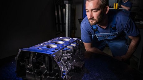 [Translate to Englisch:] ACTech team member performing the optical measurement of a cylinder head